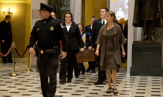 Pages lead a Senate procession carrying two boxes holding Electoral College votes through Statuary Hall to the House Chamber on Capitol Hill on Capitol Hill in Washington, Friday, Jan. 4, 2013. re-election. (AP Photo/Jacquelyn Martin)